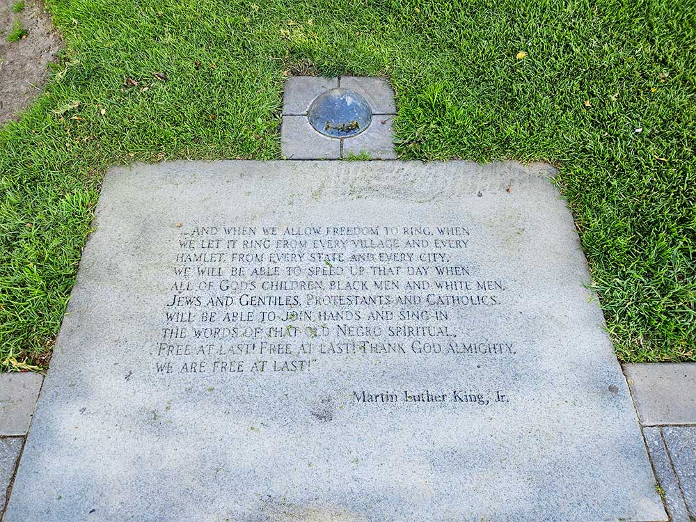 Plaque stating the Free At Least quote by Martin Luther King Jr